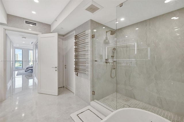 bathroom featuring plus walk in shower and tile walls