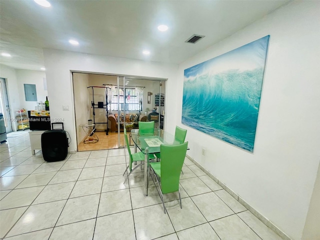 tiled dining room featuring electric panel