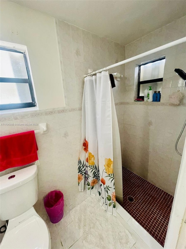 bathroom featuring walk in shower, tile patterned flooring, toilet, and tile walls