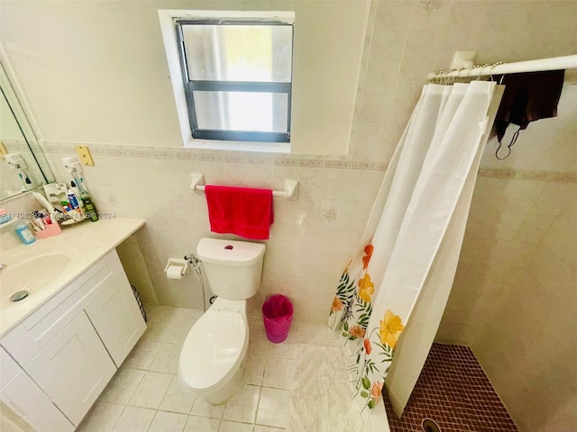 bathroom featuring tile patterned floors, vanity, tile walls, and walk in shower