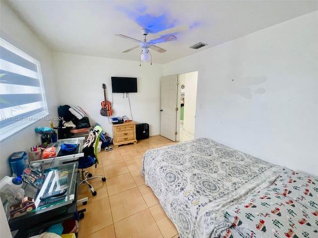 bedroom with ceiling fan and light tile patterned flooring