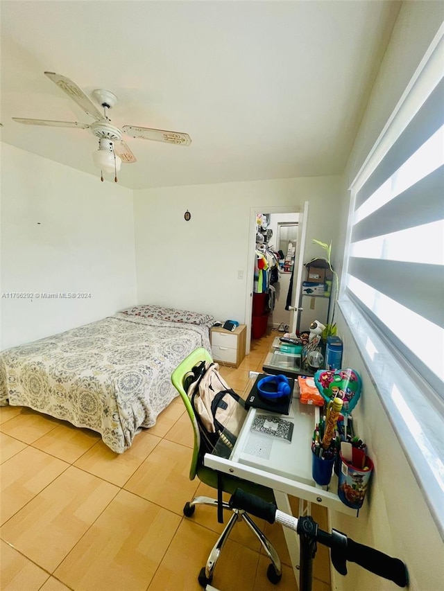 bedroom featuring a closet, a spacious closet, and ceiling fan