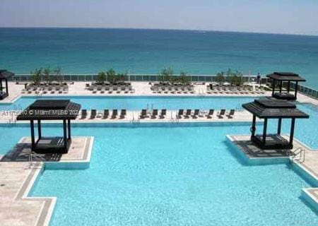 view of swimming pool featuring a water view