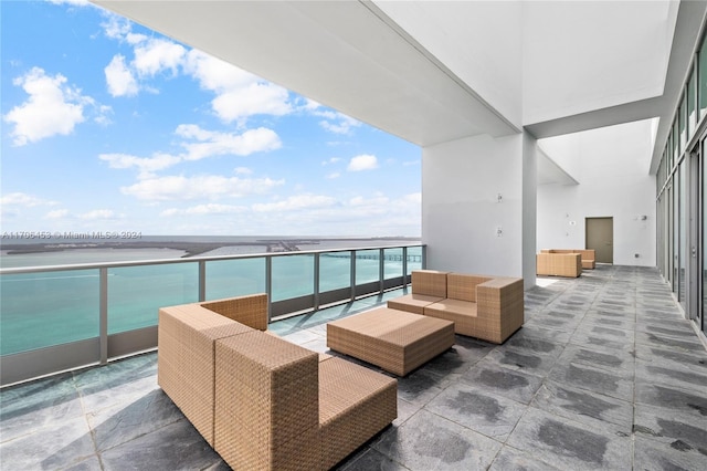 balcony featuring a water view and an outdoor hangout area