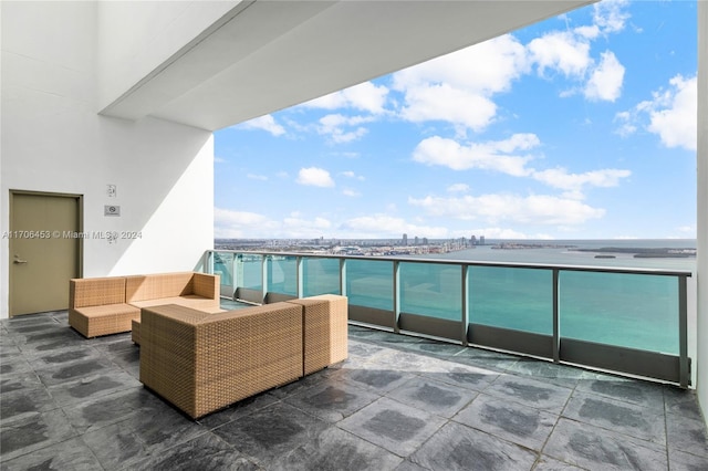 balcony featuring outdoor lounge area and a water view