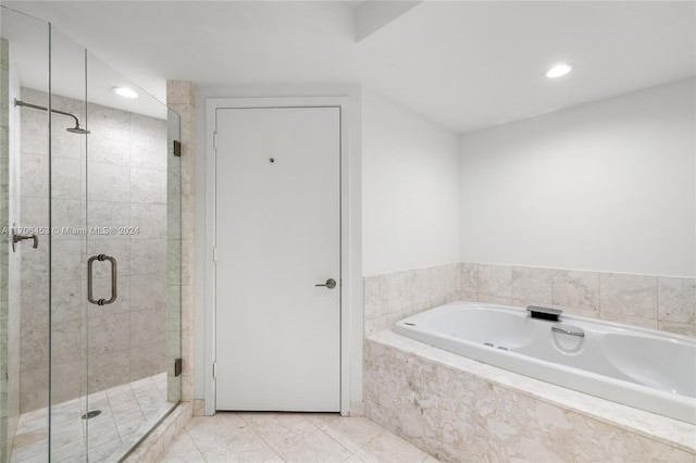 bathroom featuring tile patterned flooring and independent shower and bath