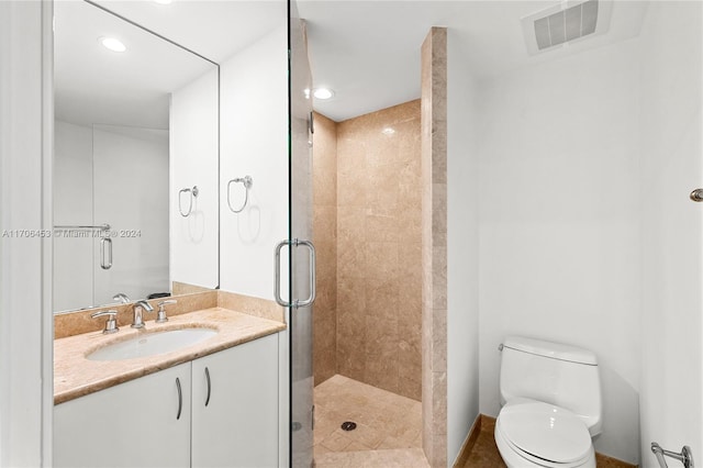 bathroom with vanity, toilet, and walk in shower