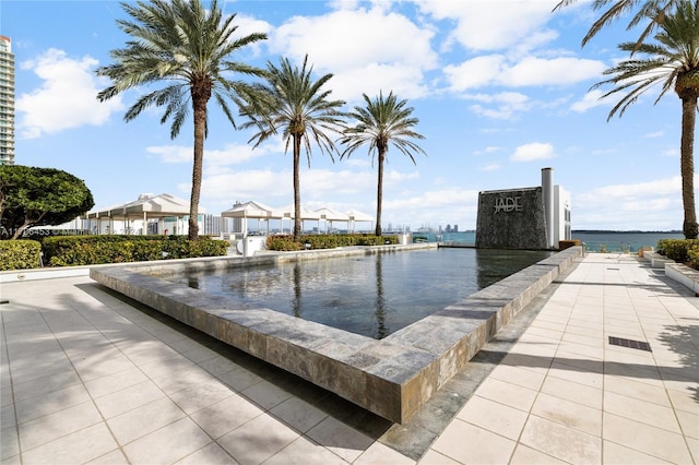 view of pool with a water view