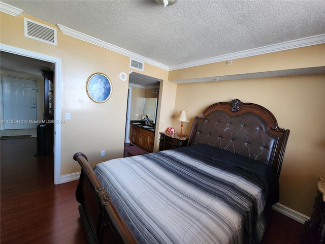 bedroom with dark hardwood / wood-style floors, ensuite bathroom, ornamental molding, and a textured ceiling