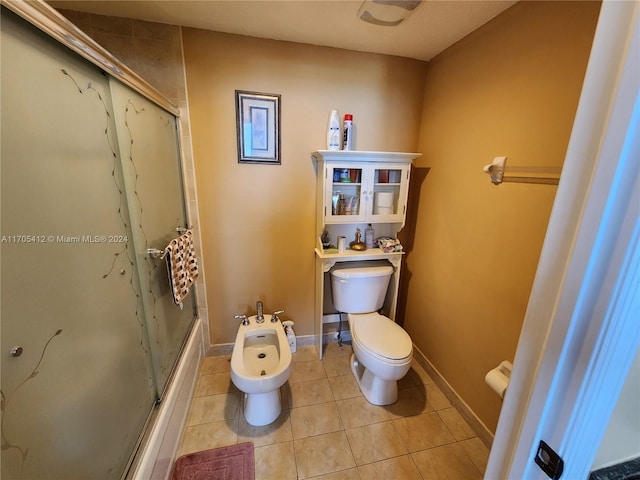 bathroom with tile patterned flooring, toilet, enclosed tub / shower combo, and a bidet