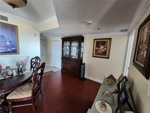 dining space featuring crown molding, dark hardwood / wood-style flooring, and a textured ceiling