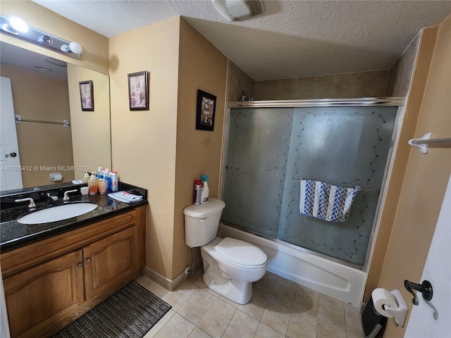 full bathroom featuring tile patterned floors, bath / shower combo with glass door, vanity, a textured ceiling, and toilet