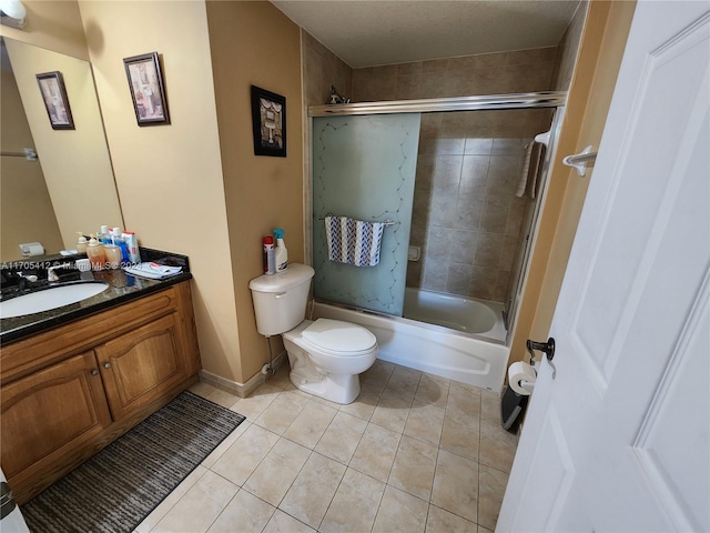 full bathroom featuring tile patterned floors, vanity, toilet, and tiled shower / bath