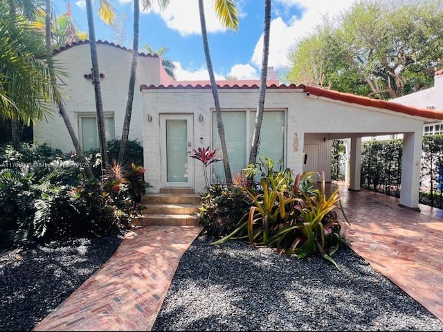 mediterranean / spanish-style home featuring a tiled roof