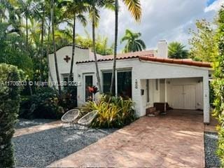 rear view of property with a carport