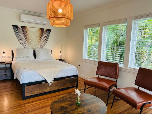 bedroom featuring wood-type flooring, an AC wall unit, and ornamental molding