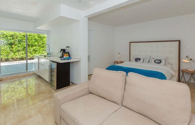 bedroom featuring access to outside, wine cooler, and sink