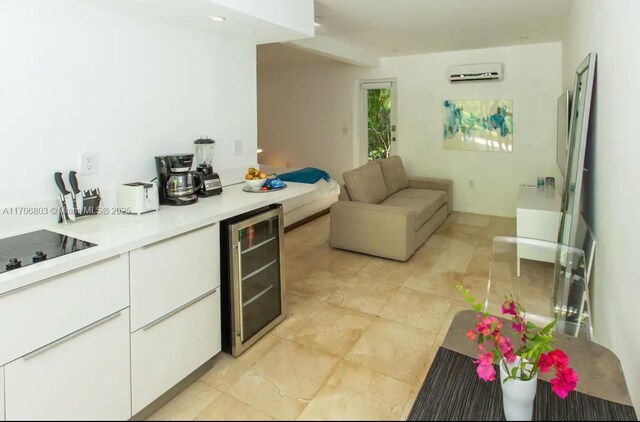 kitchen with white cabinets, black electric cooktop, wine cooler, and a wall mounted AC