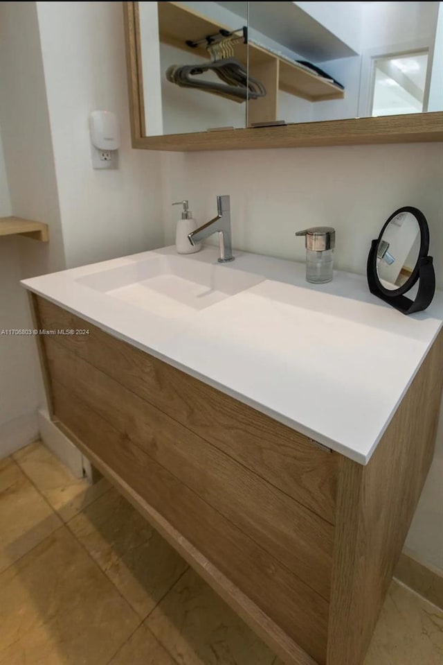 bathroom featuring tile patterned flooring and vanity