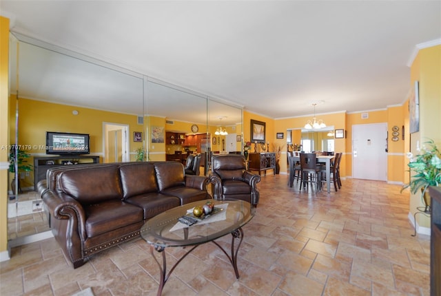 living room with crown molding and an inviting chandelier