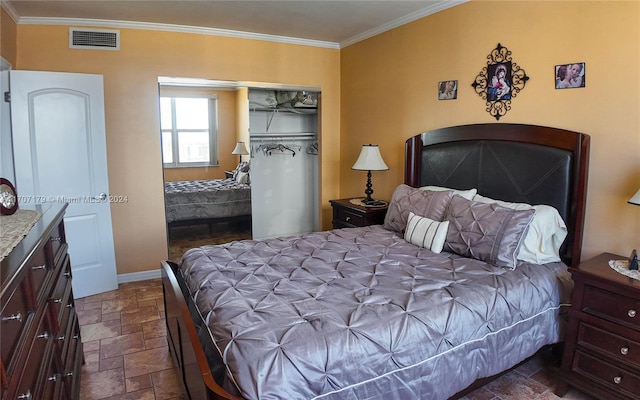 bedroom with crown molding and a closet