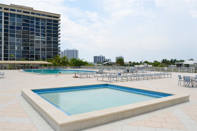 view of swimming pool featuring a patio area