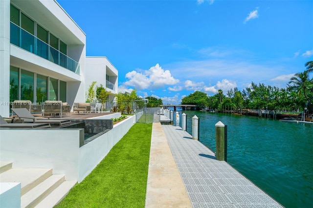 dock area with a water view and a patio area