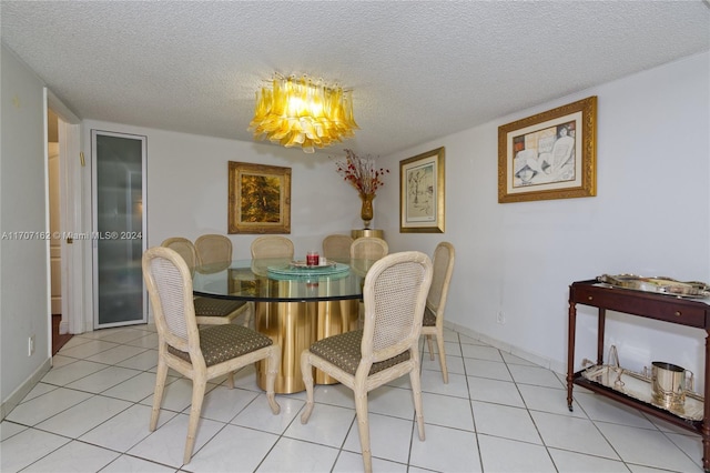 tiled dining space featuring a textured ceiling