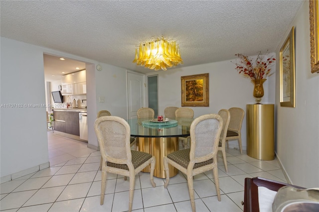 dining area with light tile patterned flooring, a textured ceiling, and a notable chandelier