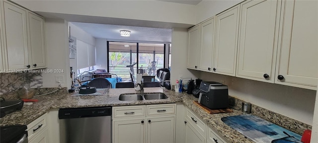 kitchen featuring light stone counters, white cabinetry, sink, and appliances with stainless steel finishes