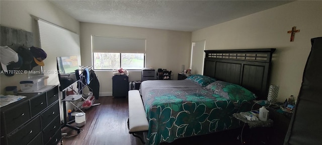 bedroom featuring a textured ceiling and dark hardwood / wood-style flooring