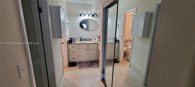 bathroom featuring tile patterned flooring and vanity