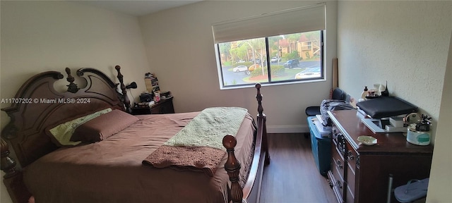 bedroom with dark hardwood / wood-style flooring