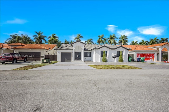 mediterranean / spanish home featuring central AC and a garage