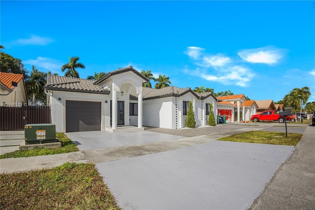 mediterranean / spanish home with a garage