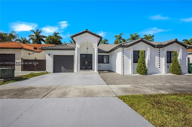 mediterranean / spanish-style house with a garage