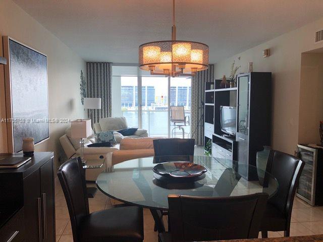 dining space with light tile patterned floors and wine cooler