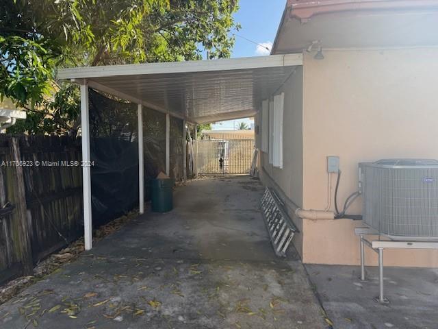 view of parking / parking lot featuring a carport