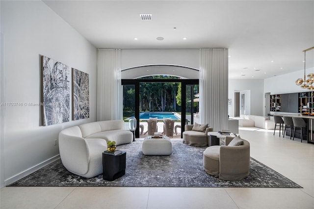 tiled living room with a chandelier