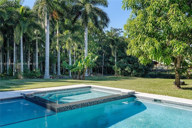 view of pool with a yard