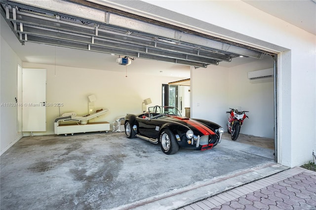 garage with a wall unit AC and a garage door opener