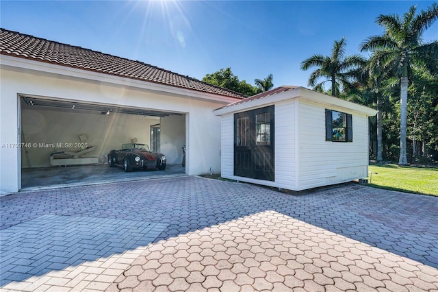 rear view of house featuring a garage