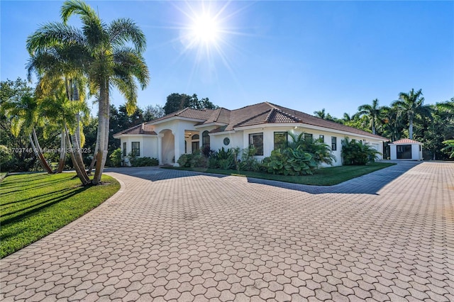 mediterranean / spanish-style house with a front yard