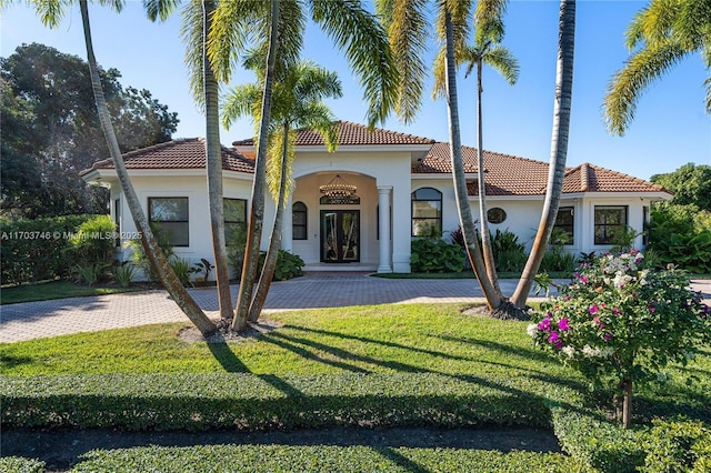 mediterranean / spanish home featuring a front yard