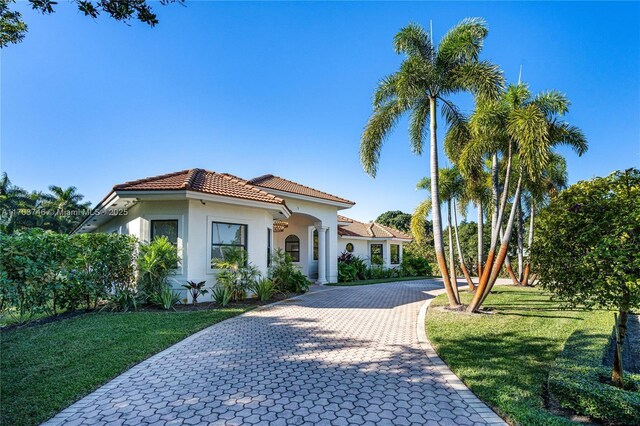 mediterranean / spanish home featuring a front yard