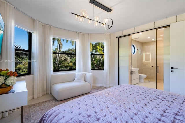 tiled bedroom with a closet, connected bathroom, and a notable chandelier