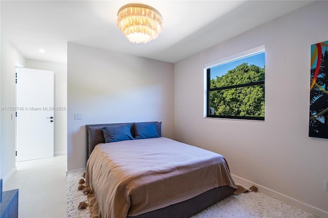 bedroom featuring a notable chandelier