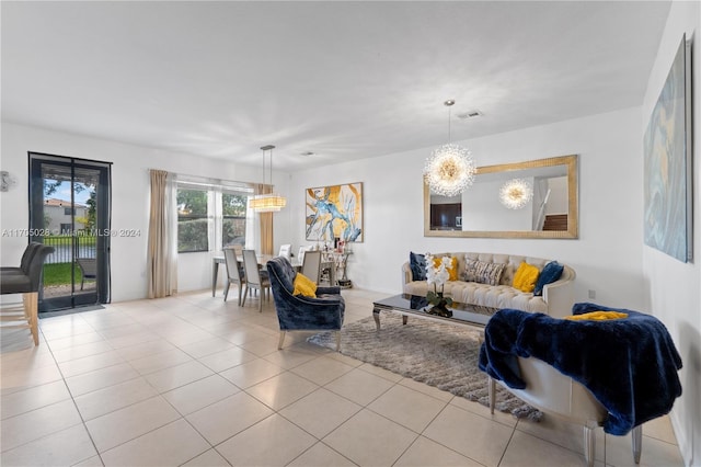 living room featuring light tile patterned floors and a notable chandelier