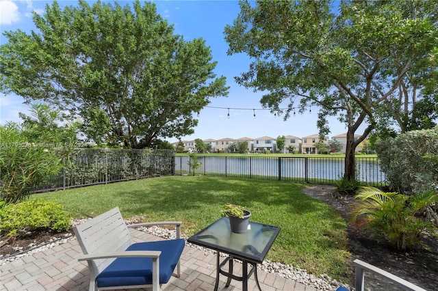 view of yard with a patio area and a water view