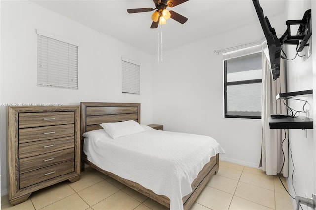 bedroom with ceiling fan and light tile patterned floors